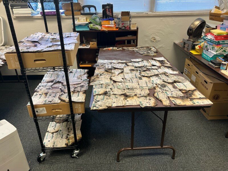 In this photo released by Clark County Elections, some of the ballots damaged in the fire at the Fisher&rsquo;s Landing C-Tran Transit Center ballot box are shown. Elections staff identified 488 damaged ballots retrieved from the box, although some may have been destroyed entirely. Voters who deposited ballots at the Fisher&rsquo;s Landing ballot box after 11 a.m. on Saturday, Oct. 26, can check to see if their ballot was received by going to votewa.gov.