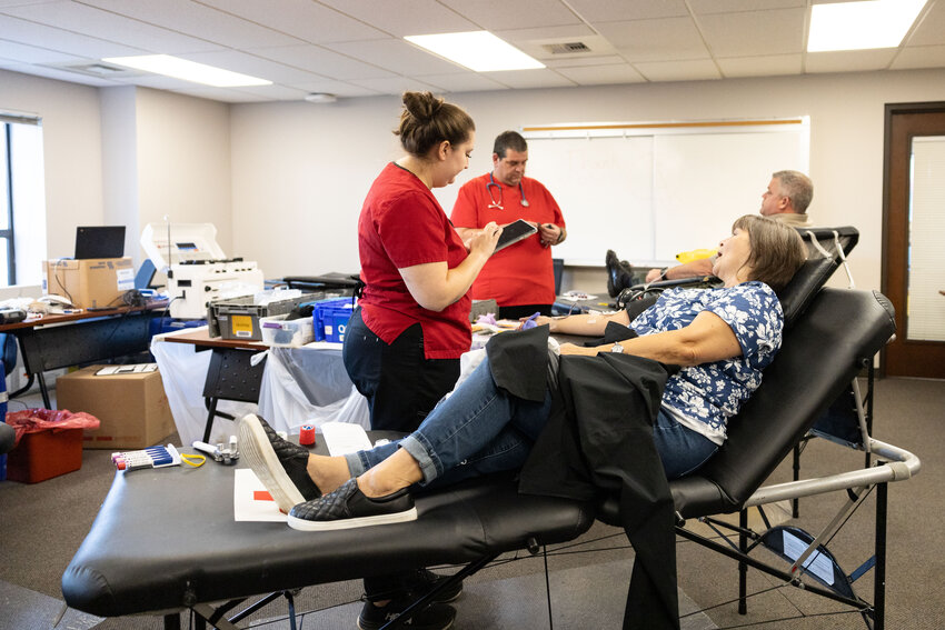 Shari Watt talks to Red Cross employee Brianna Buchanan while donating blood at an American Red Cross blood drive in the Lewis County Courthouse in Chehalis on Tuesday, Oct. 29, 2024.