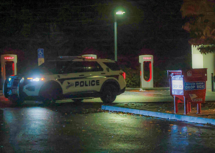 In wake of recent ballot box fires in Portland and Vancouver, a Ridgefield police officer patrols the ballot box at the Ridgefield Park and Ride around 9 p.m. on Wednesday, Oct. 30.