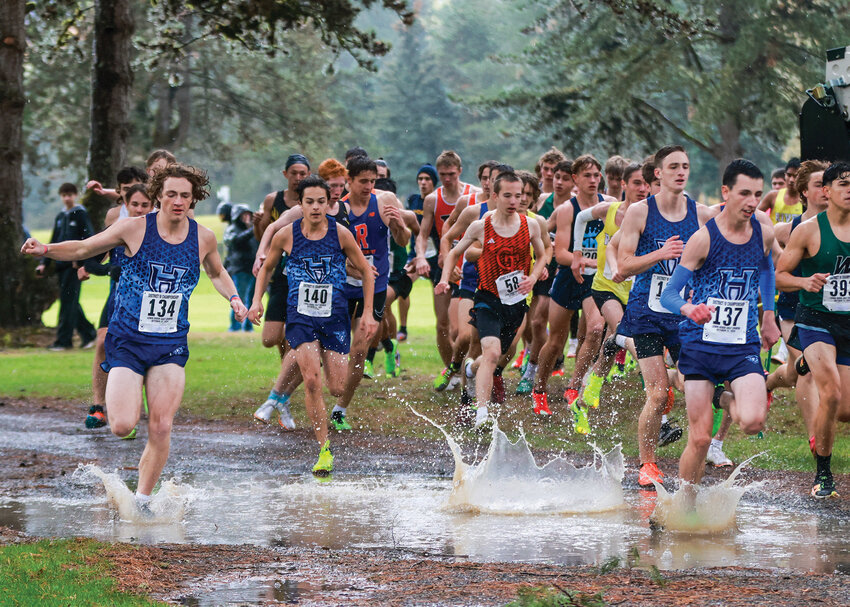 A pack of four Hockinson boys cross country runners splash through a large puddle at the first corner of the cross country course at the Lewis River Golf Course at the District 4 1A/2A Championships on Thursday, Oct. 31. The Hawks boys team earned third place, qualifying Hockinson for the state championship tourney in Pasco on Saturday, Nov. 9.