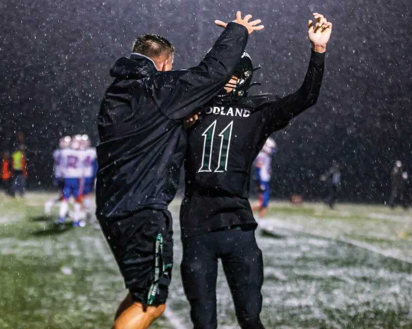 Woodland Beavers head coach Glen Flanagan celebrates with defensive back Niel Valerio after he caught the game-sealing interception for the Beavers to repeat as 2A Greater St. Helens League champions with a 14-7 win over Ridgefield High School on Friday, Nov. 1.