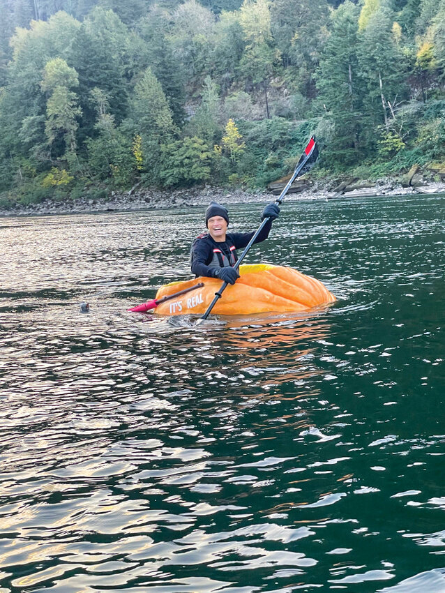 Gary Kristensen paddles his giant pumpkin down the Columbia River.