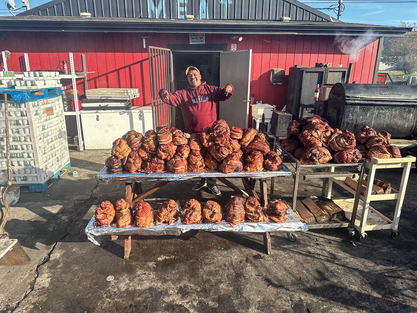 Donnie Vercher, founder of Dream for Life, holds hams donated by the community and sponsors for the upcoming free Thanksgiving dinners in Woodland and Vancouver. People have until Nov. 20 to donate food items and monetary donations to the nonprofit for the event.