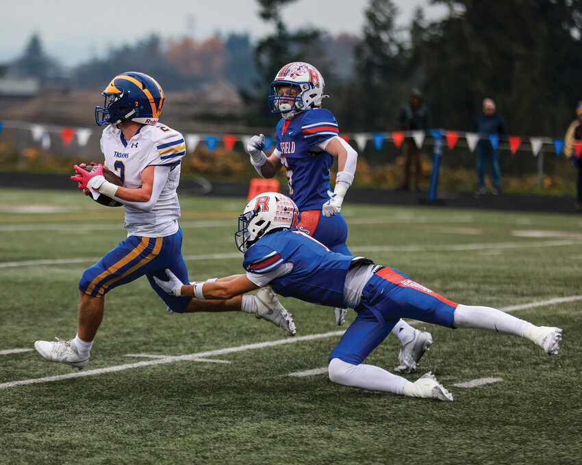 Ridgefield&rsquo;s Chase Hall dives to try and make a stop during a Fife touchdown run in the Spudders&rsquo; 34-7 loss to the Fife Trojans in the state preliminary round on Saturday, Nov. 9.