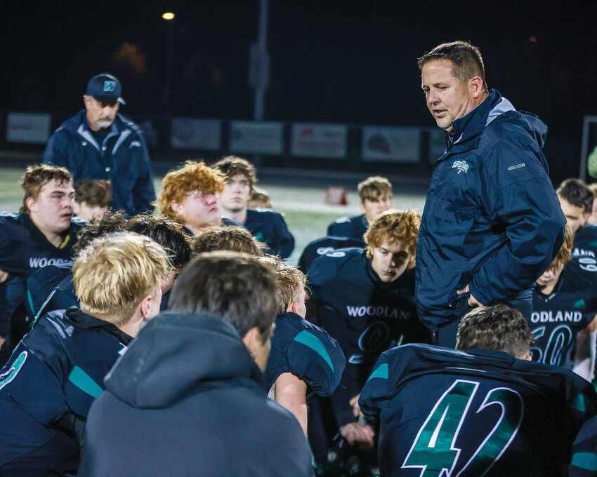 Glen Flanagan, Woodland Beavers head coach, speaks to his team after a 34-14 season-ending loss against the Cedarcrest Red Wolves in the preliminary state football round on Friday, Nov. 8.