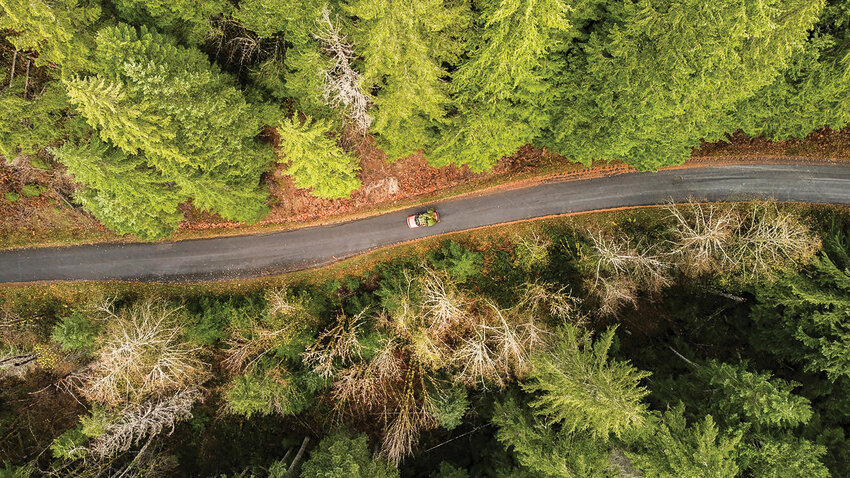 A Christmas Tree sits atop a vehichle traveling down Forest Road 23 in the Gifford Pinchot National Forest on Tuesday.