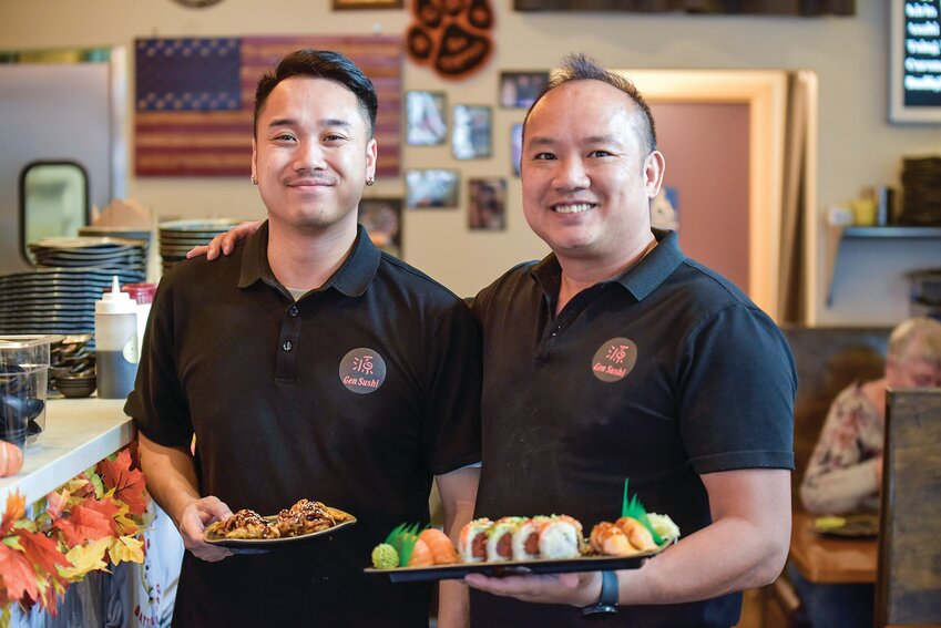 Gen Sushi owner Eddie Zhen (right) holds a plate of sushi next to server Jay Li. Since opening in February 2023, Gen Sushi has hired 16 staff members to keep up with the high demand.