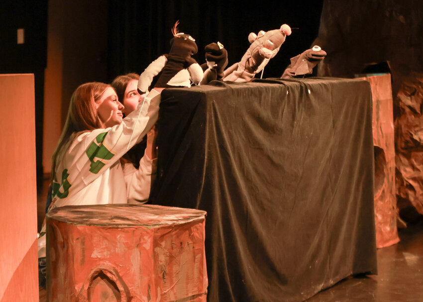 View Ridge Middle School students Ryan Bellah, left, and Sunday Libby, with other hidden puppeteers, perform a skit for elementary school students in a puppet show on Thursday, Nov. 21.