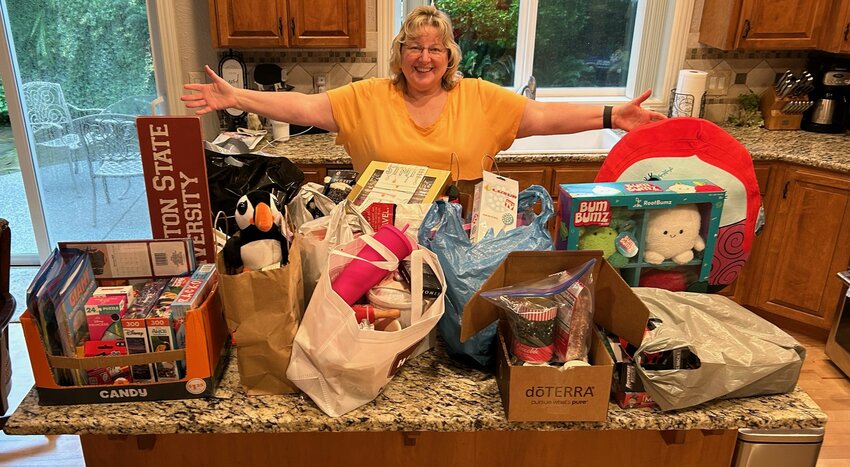 Ridgefield Lions Club Service Chair Shannon Schick surveys a small sampling of toys donated to the Ridgefield School District Family Resource Center during a group community service initiative.
