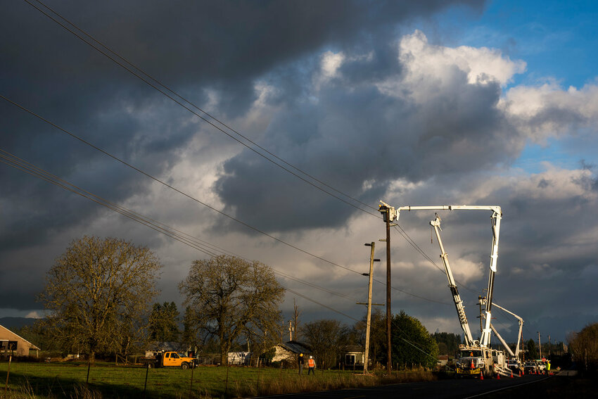 PUD workers reconstruct three power-line poles along Gore Road in Ethel in this Chronicle file photo.