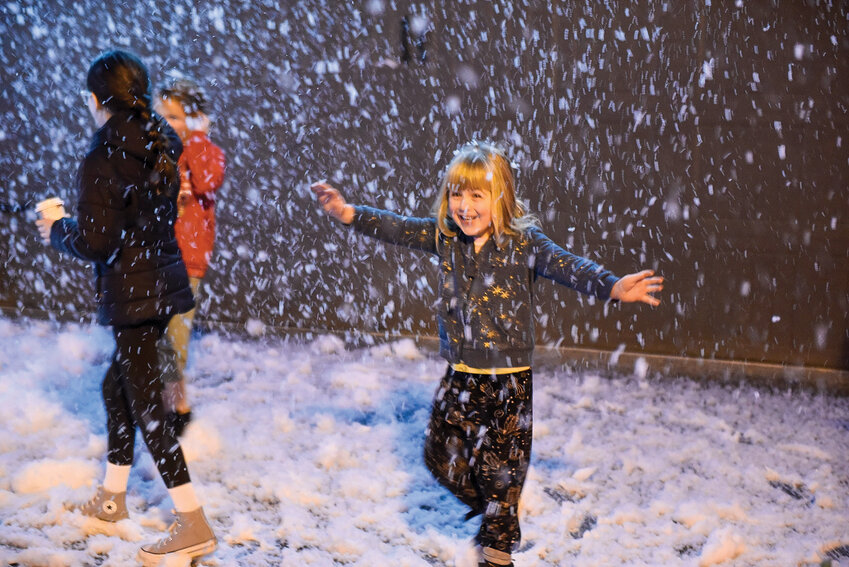 Children play in the driveway of one Bella Noche HOA resident, who set up a snow machine for families to take pictures. On Saturday, Dec. 14, the neighborhood held its third annual Candy Cane Lane, a free event for families to celebrate the holiday season.