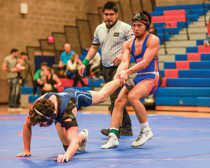 Ridgefield&rsquo;s Preston Javier pulls his Mark Morris opponent back into the circle en route to securing a tech fall win at 138 pounds during a dual meet win on Wednesday, Dec. 18.