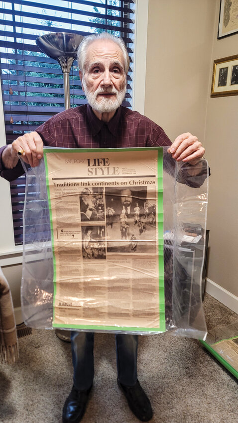 Antonio Aiello holds up a Dec. 24, 1988, newspaper page from the News Chronicle in Thousand Oaks, California, where his nativity set was highlighted as a family tradition connecting the Aiello family back to Italy each holiday season.