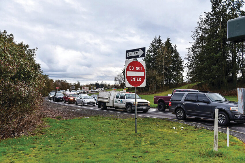 Interstate 5&rsquo;s Exit 21 interchange is backed up during rush hour in Woodland. Breaking ground for an improved interchange may be delayed from 2026 to 2028 due to a mandated environmental assessment due to staffing shortages at the state level. Woodland Public Works Director Riley Bunnell remains optimistic that the city can move forward without the assessment, arguing it may be exempt from the requirement.