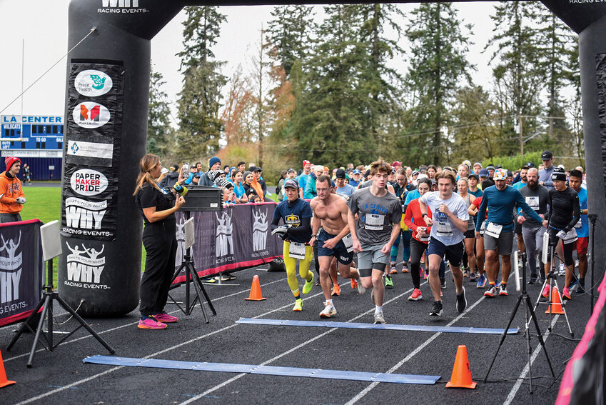 Runners take off at the start of the 10K portion of the third annual La Center Resolution Run, Saturday, Jan. 4, at La Center High School. The event, including 5K and 10K races, raises funds to support La Center High School&rsquo;s volleyball and track and field programs. Hundreds of participants from near and far gathered to take part.