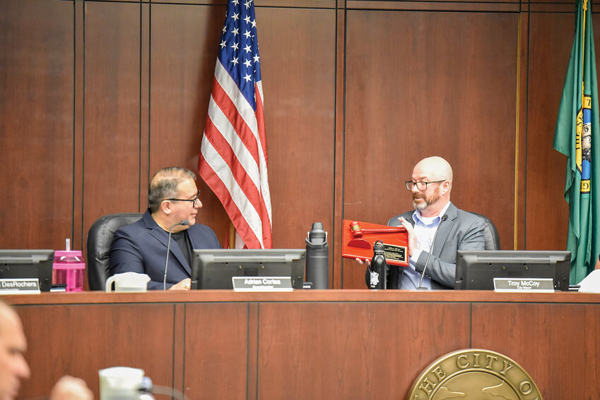 Battle Ground Mayor Troy McCoy presents Adrian Cortes with a commemorative plaque and gavel during Cortes' final City Council meeting on Jan. 6. Cortes resigned last week after 13 years of service to the council following his election to the state Senate for Washington&rsquo;s 18th Legislative District.