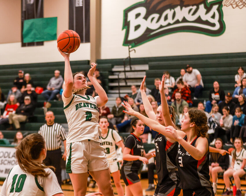 Woodland sophomore forward Kennedy Bockert hooks a shot, well above the R.A. Long defenders during the Beavers&rsquo; 66-37 win on Wednesday, Jan. 8.