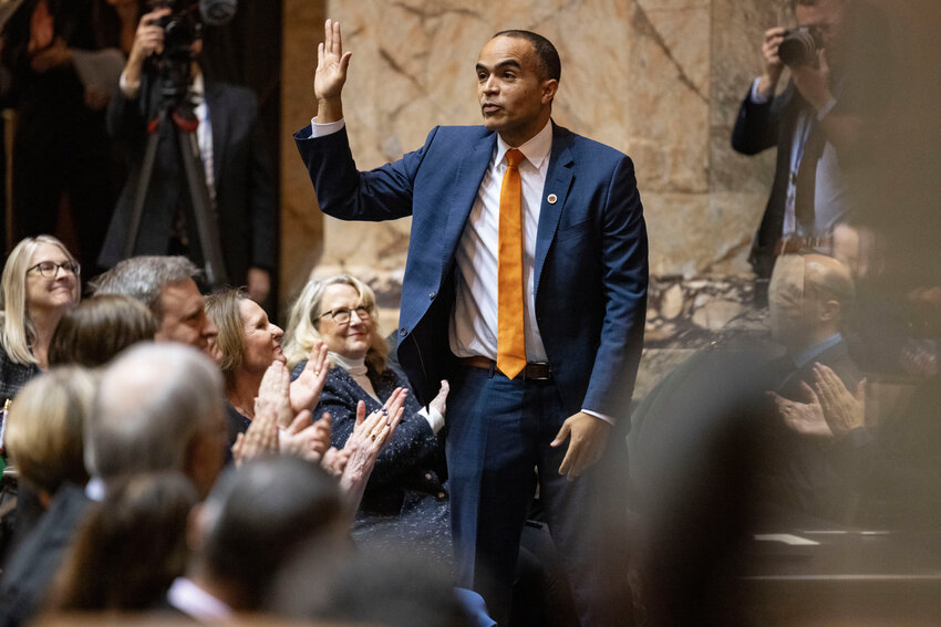 Attorney General Nick Brown waves to lawmakers during a joint legislative session in the House chambers at the Washington State Capitol in Olympia on Wednesday, Jan. 15.