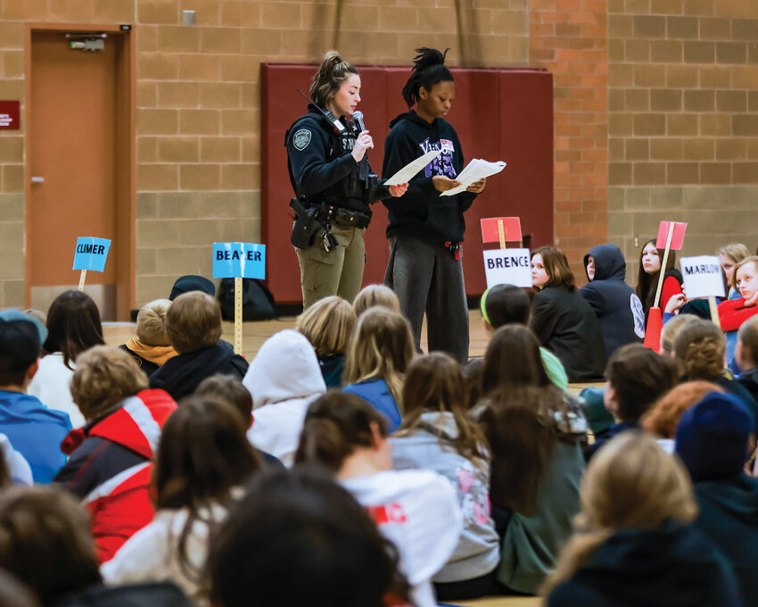 Clark County Sheriff&rsquo;s Office deputy and Prairie High school resource officer Chelsea Quiggle, left, and Prairie High School student and Black Student Union member Faith Prospere read a poem they wrote at a Martin Luther King Jr. Day assembly at Daybreak Middle School on Tuesday, Jan. 21.