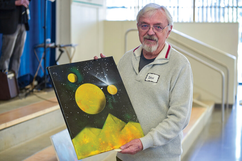 La Center artist Dan Masterson shows his spray-painted work during a La Center Arts Council meeting on Sunday, Jan. 26, at La Center Middle School. The nonprofit plans to expand its impact with new public art projects, including student-created murals and a variety of community workshops, all aimed at transforming La Center into a vibrant arts destination.