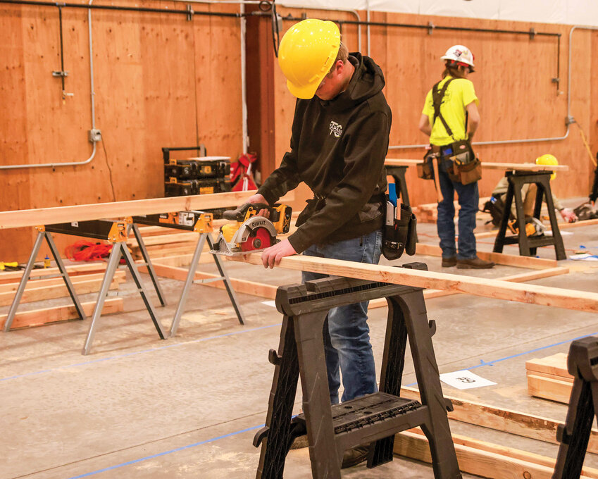 Hockinson High School career and technical education student Lars Sarkinen makes a cut on a board during a SkillsUSA carpentry competition in Ridgefield in January. Sarkinen earned second place in the competition.