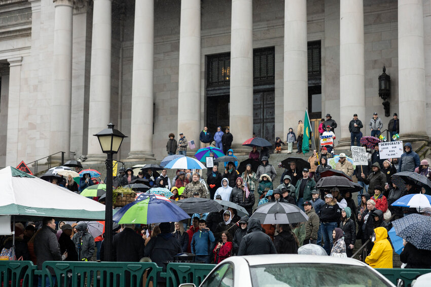 Rally participants and speakers gather in front of the Washington state Capitol in support of protecting parents&rsquo; rights in Olympia on Saturday, Feb. 15.