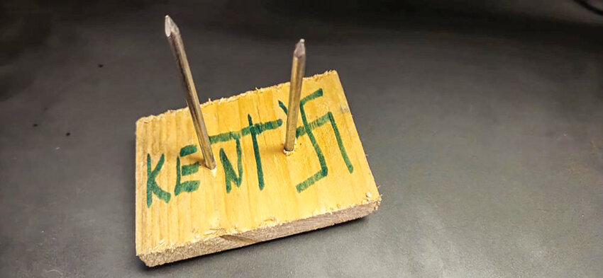 Three wooden boards with spikes inscribed with &ldquo;Kent&rdquo; and a swastika symbol were found between Feb. 5-7 on Yacolt roadways inside town limits.