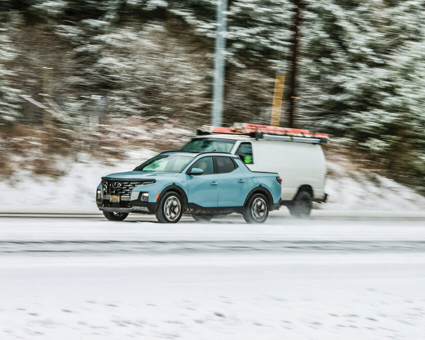 A driver on northbound state Route 503 near Lewisville Park passes another vehicle in snowy conditions on Thursday, Feb. 13.