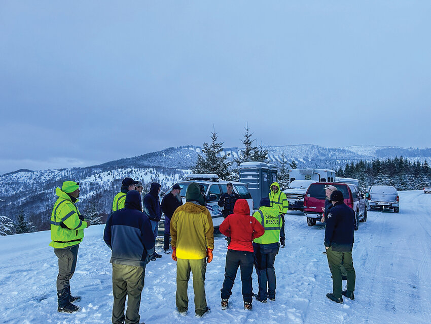 Emergency responders gather during a search for a Ridgefield man who became disoriented and lost in winter weather near Coldwater Lake on Feb. 7.