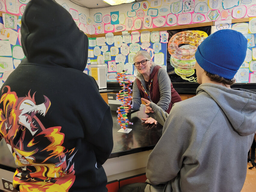 Holly Koon, a high school biology teacher for over 30 years, works through a lesson with two of her students at Mount Baker High School.&nbsp;