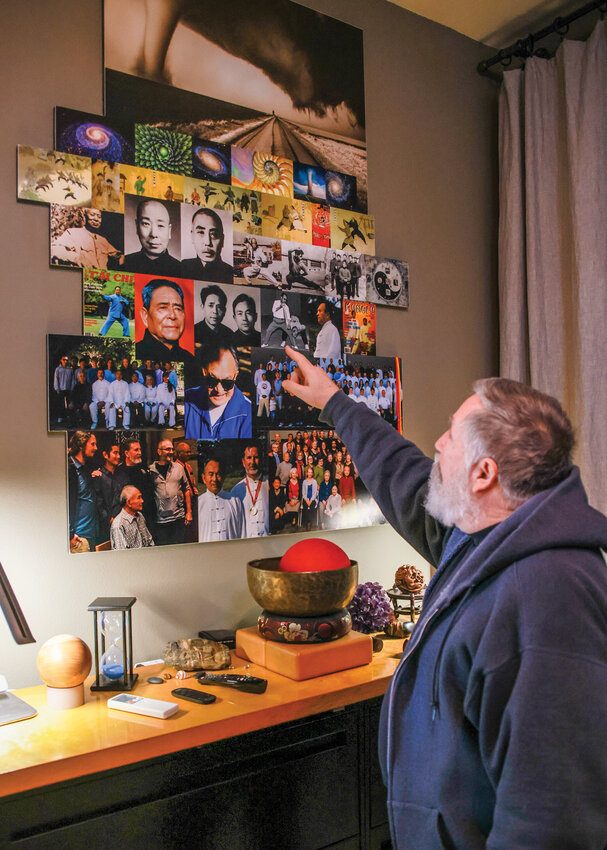 Malcolm Dean, of Battle Ground, points to a wall showcasing the heritage and lineage of Taiji on Thursday, Feb. 20.