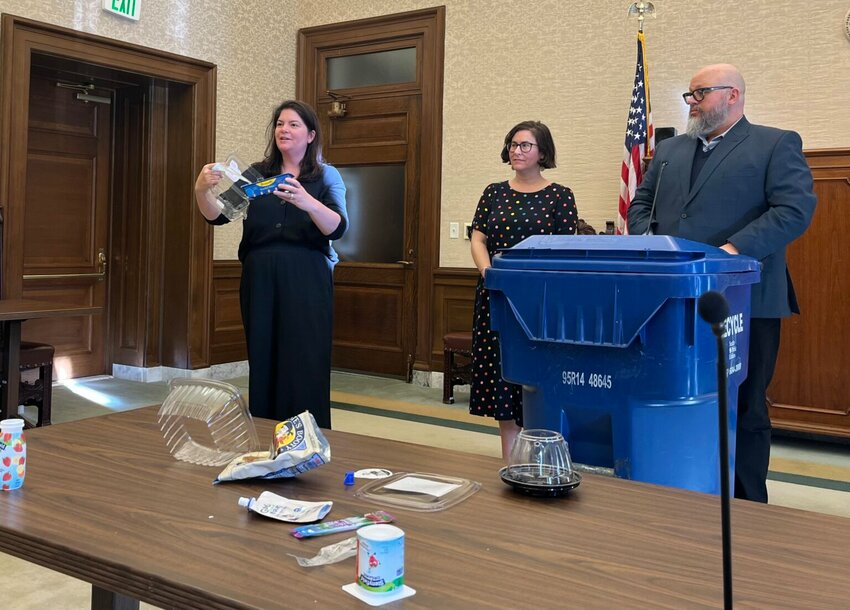 Rep. Liz Berry, D-Seattle, shows the different types of containers that her family&rsquo;s fruit came in this week. Berry, along with Sen. Liz Lovelett, D-Anacortes, and Dylan de Thomas, at the Recycling Partnership, spoke to reporters about a new bill to require manufacturers to pay for recycling. (Photo by Laurel Demkovich/Washington State Standard)