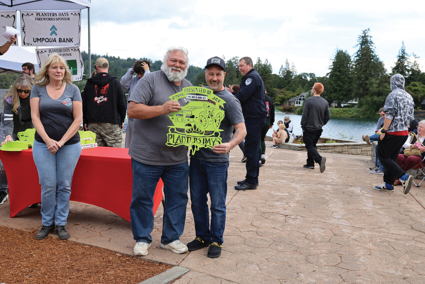 A Columbia River Camaro Club (CRCC) member presents the "Best of Show" award during last year's Woodland Planters Days Sunday car show. CRCC has hosted the Woodland Planters Days car show since 2021.