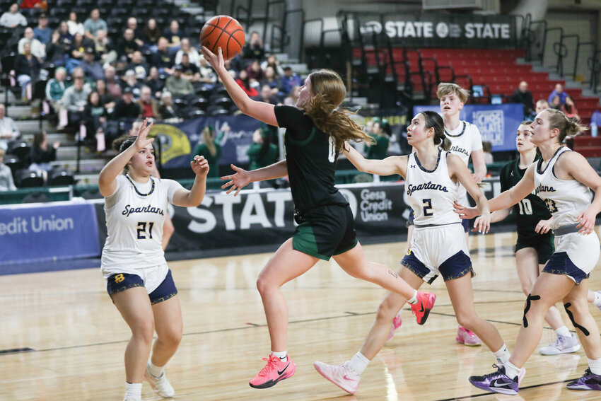 Woodland's Addi Stading goes up with her right for an underhanded layup during Woodland's 44-40 overtime loss to Bainbridge in the Round of 12 at the 2A State Tournament in Yakima on March 5.