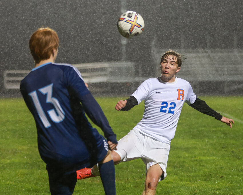 Ridgefield&rsquo;s Simone Ambrosini, No. 22, and Hockinson&rsquo;s Kieran Harwood go for the ball as rain falls during Hockinson&rsquo;s win on Thursday, March 13.