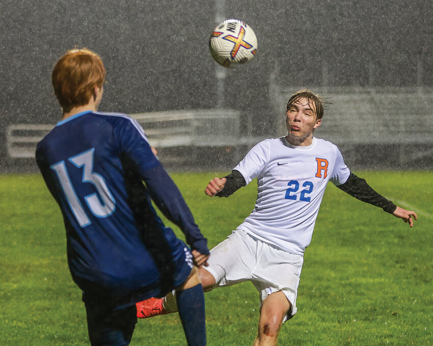 Ridgefield&rsquo;s Simone Ambrosini, No. 22, and Hockinson&rsquo;s Kieran Harwood go for the ball as rain falls during Hockinson&rsquo;s win on Thursday, March 13.