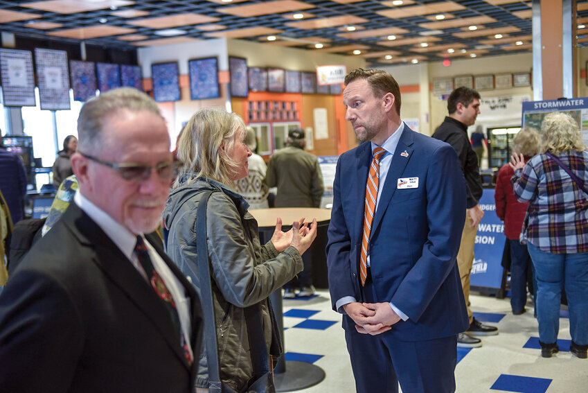 Mayor Matt Cole speaks with a community member outside the auditorium before the State of the City meeting on Tuesday, March 18. The event brought residents together to discuss Ridgefield&rsquo;s plans and initiatives.