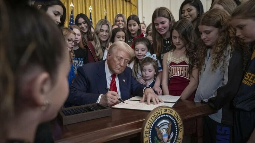 President Donald Trump signs an executive order to keep trans women out of women's sports in the East Room of the White House in Washington, D.C., on Wednesday, Feb. 5, 2025.