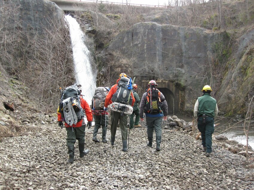 Employees of the U.S. Forest Service and members of the North Country Volcano Rescue Team hike through the Spirit Lake drainage tunnel in March 2016. The Forest Service is reviewing ways to update or replace the aging tunnel.