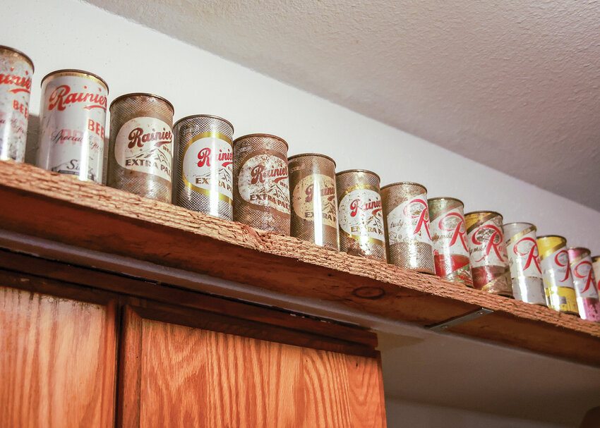 A line of old Rainier beer cans owned by Amboy resident Jeffrey Berry shows just a small portion of Rainier beer cans, bottles and memorabilia in his collection.