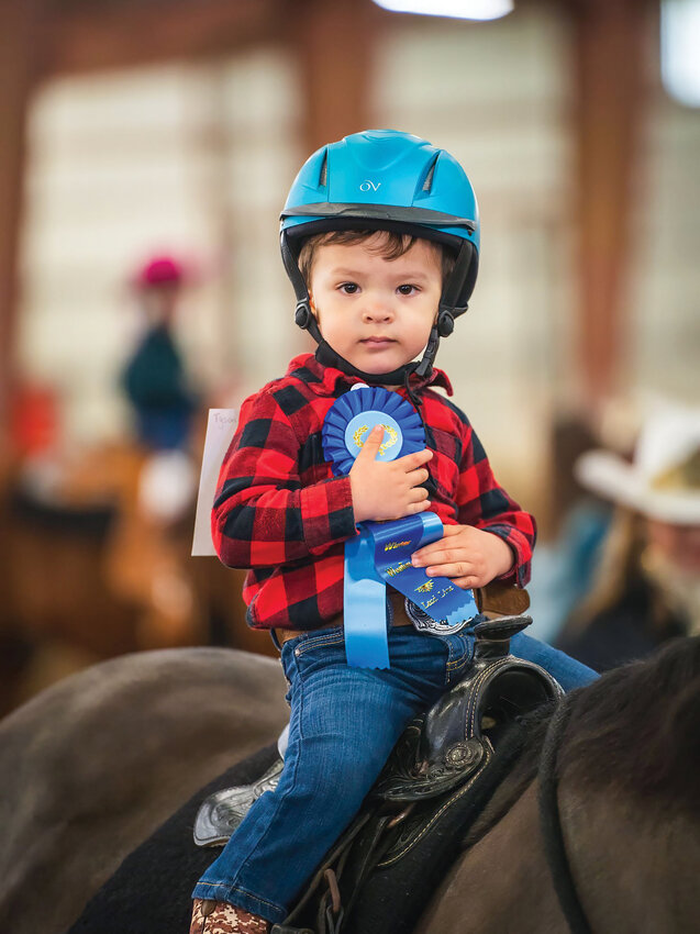 Tyson, a 2-year-old competitor, holds a winning ribbon. The Winter Woolies Horse Show, now in its 40th year, offers a variety of classes for riders of all ages.