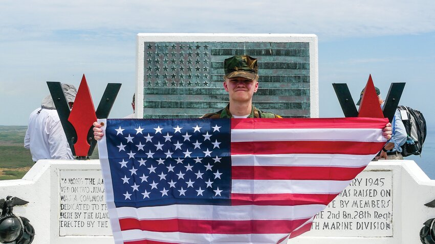 Honoring the World War II Marines killed in the Battle of Iwo Jima, Young Marine Sergeant Major Tristan Begines, of Vancouver, stands atop Mount Suribachi, Iwo Jima, Japan.