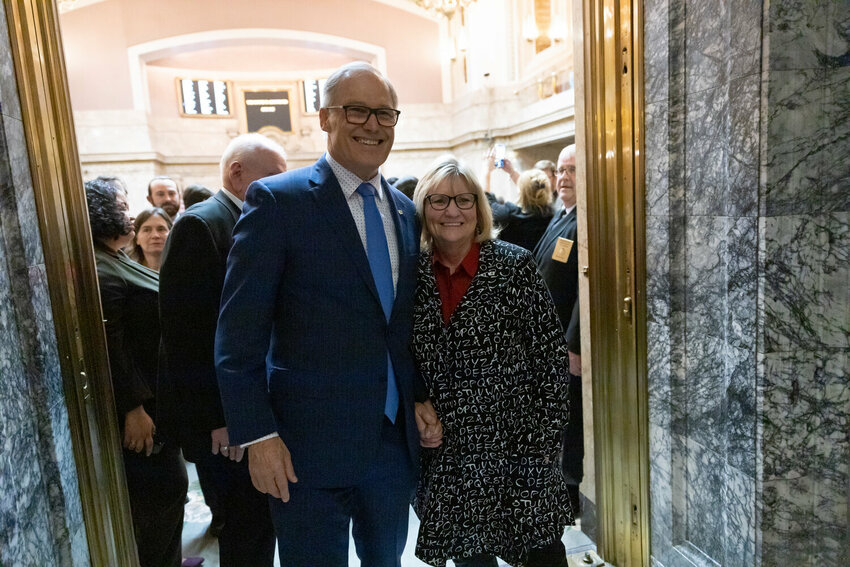 Gov. Jay Inslee and Trudi Inslee pose for a photo on the last day of the 2024 Legislature at the state Capitol on Thursday, March 7, 2024.