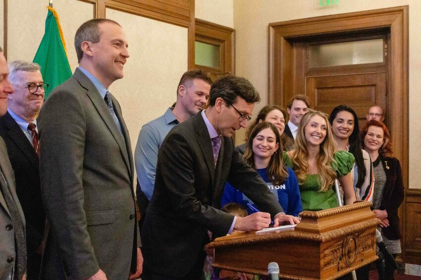 Gov. Bob Ferguson signing Senate Bill 5480, a bill that would exempt medical debt from credit reports, on April 22, 2025. (Photo by Jacquelyn Jimenez Romero/Washington State Standard)