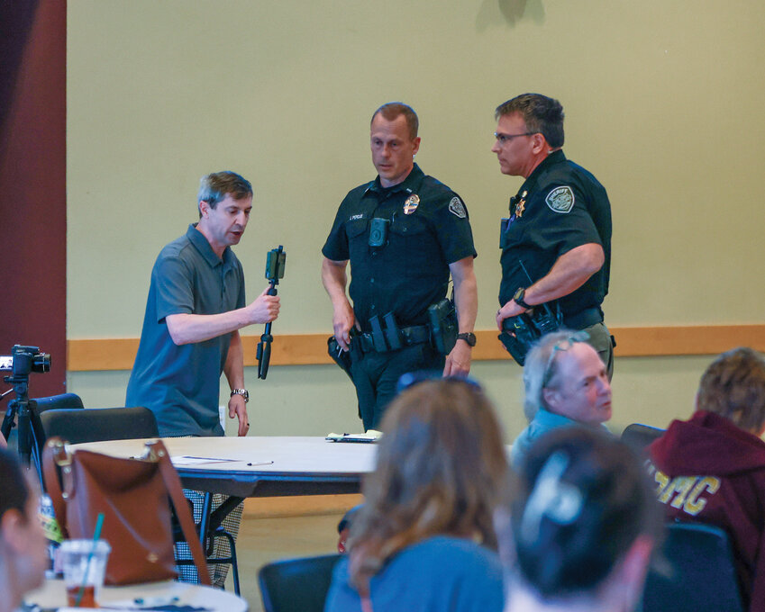 Leonid Krivolenkov, a First Amendment auditor who goes by his YouTube Channel&rsquo;s name, &ldquo;Siberian Tiger,&rdquo; interrupts a public safety town hall with Battle Ground Police Chief Dennis Flynn and Clark County Sheriff John Horch on Wednesday, April 23, at the Battle Ground Event Center.