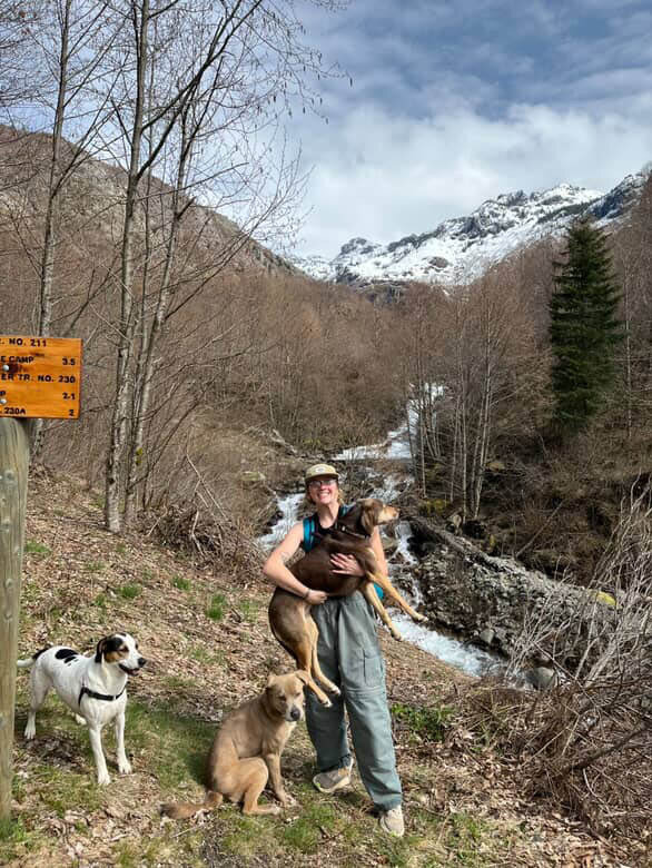 Emma Mathson poses for a photo with her three dogs while on a hiking trip to Coldwater Lake on April 10.