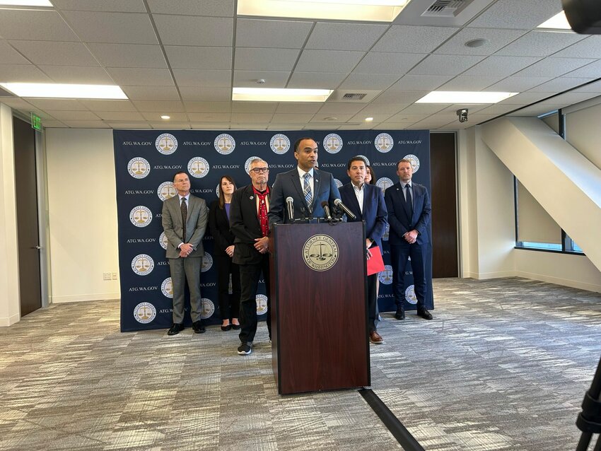 Attorney General Nick Brown (center) announces a lawsuit against the Trump administration in Seattle, Washington, on May 9, 2025, over its declaration of an energy emergency. (Jake Goldstein-Street/Washington State Standard)