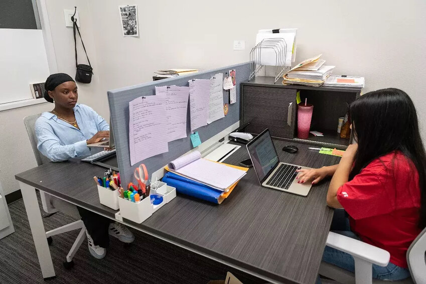 Legal assistants Analesa Mason, left, and Alondra Maqueda, right, work in their shared office at The Way to Justice in Spokane. (Photo by Erick Doxey/InvestigateWest)