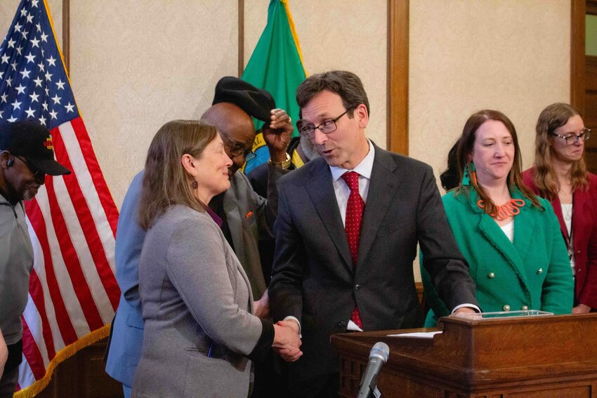 Gov. Bob Ferguson shakes hands with Sen. June Robinson, chair of the Ways and Means committee, after signing the operating budget on May 20, 2025 in Olympia. (Photo by Jacquelyn Jimenez Romero/Washington State Standard)