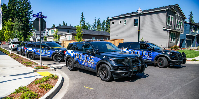Battle Ground Police vehicles and crime scene tape close off the 2100 block of Northeast Second Avenue in Battle Ground on Tuesday, June 3 as the Battle Ground Police Department and the Clark County Major Crimes Team are investigating a double homicide in a home.